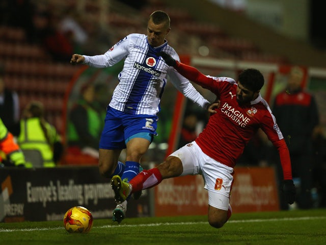 Jason Demetriou (L) of Walsall is challenged by Yaser Kasim (R) of Swindon Townduring the Sky Bet League One match between Swindon Town and Walsall at the County Ground on November 24, 2015