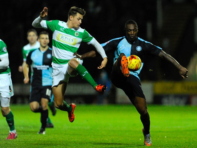 Anthony Stewart of Wycombe Wanderers is tackled by Harry Cornick of Yeovil Town during the Sky Bet League Two match between Yeovil Town and Wycombe Wanderers at Huish Park on November 24, 2015