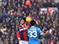 Bologna's defender from Morocco Adam Masina (L) jumps for the ball with Napoli's defender from Spain Raul Albiol during the Italian Serie A football match Carpi vs AC Milan at the Dall'Ara stadium in Bologna on December 6, 2015.