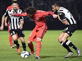 Paris Saint-Germain's French midfielder Adrien Rabiot (L) vies with Angers' Moroccan midfielder Romain Saiss during the French L1 football match between Angers (SCO) and Paris Saint-Germain (PSG), on December 1, 2015, at the Jean Bouin stadium, in Angers,