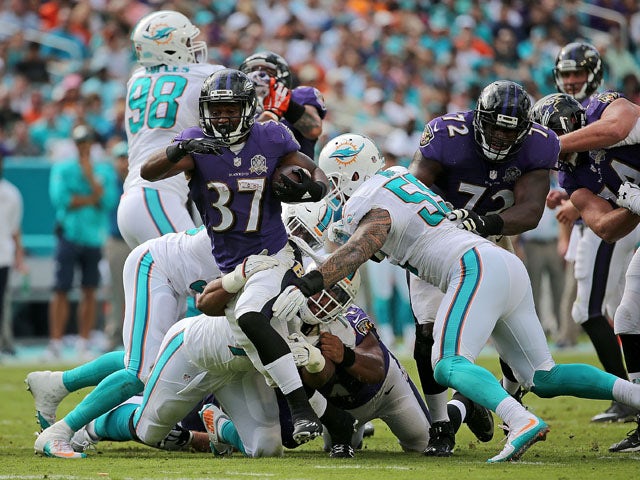 Javorius Allen #37 of the Baltimore Ravens rushes during a game against the Miami Dolphins at Sun Life Stadium on December 6, 2015