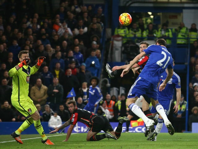 Chelsea's Serbian midfielder Nemanja Matic (R) heads the ball over the bar during the English Premier League football match between Chelsea and Bournemouth at Stamford Bridge in London on December 5, 2015.