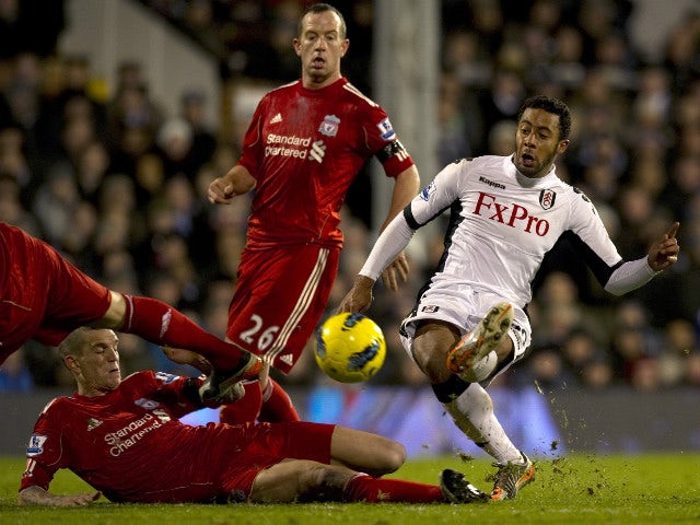 Fulham's Mousa Dembele (R) shoots at goal past a challenge from Liverpool's Danish player Daniel Agger (L) during the English Premier League football match at Craven Cottage in London on December 5, 2011. Fulham won the game 1-0.