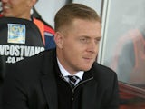 Swansea Citys English manager Garry Monk sits in the dugout during the English Premier League football match between Swansea City and Leicester City at The Liberty Stadium in Swansea, south Wales on December 5, 2015.