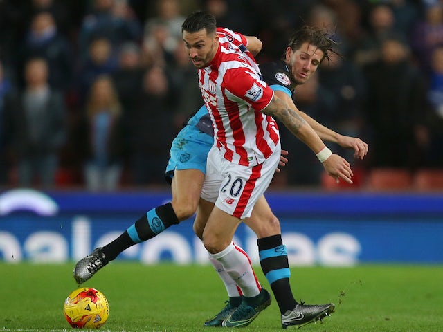 Geoff Cameron of Stoke City and Sam Hutchinson of Sheffield Wednesday compete for the ball during the Capital One Cup match between Stoke City and Sheffield Wednesday at the Britannia Stadium on December 1, 2015 in Stoke-on-Trent, England. 