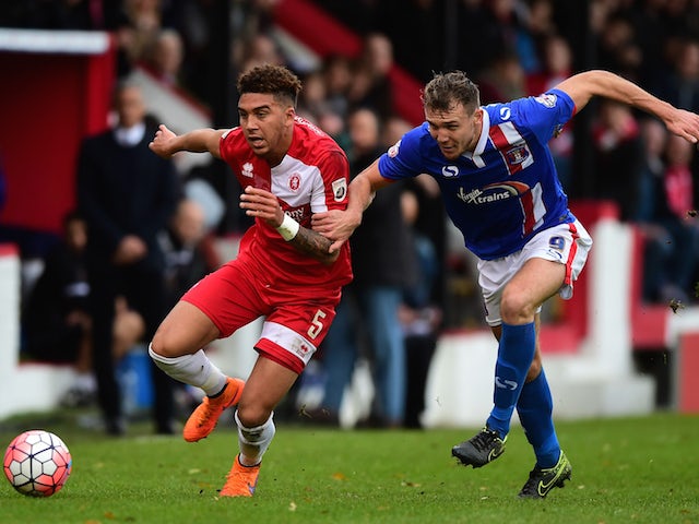 Harry Osborne of Welling United (L) battles for the ball with Charlie Wyke of Carlisle United during the Emirates FA Cup Second Round match between Welling United and Carlisle United at Park View Road on December 6, 2015 in Welling, England. 