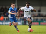 Joe Dodoo of Bury beats Donal McDermott of Rochdale during The Emirates FA Cup Second Round match between Rochdale and Bury at Spotland on December 6, 2015 in Rochdale, England.