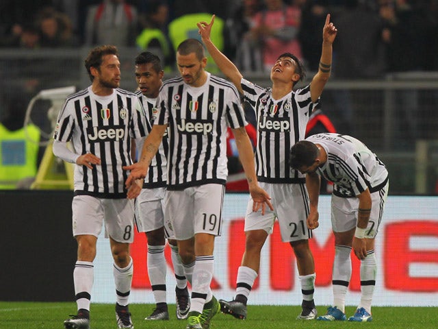 Paulo Dybala #21 with his teammates of Juventus FC celebrates after scoring the team's second goal during the Serie A match between SS Lazio and Juventus FC at Stadio Olimpico on December 4, 2015