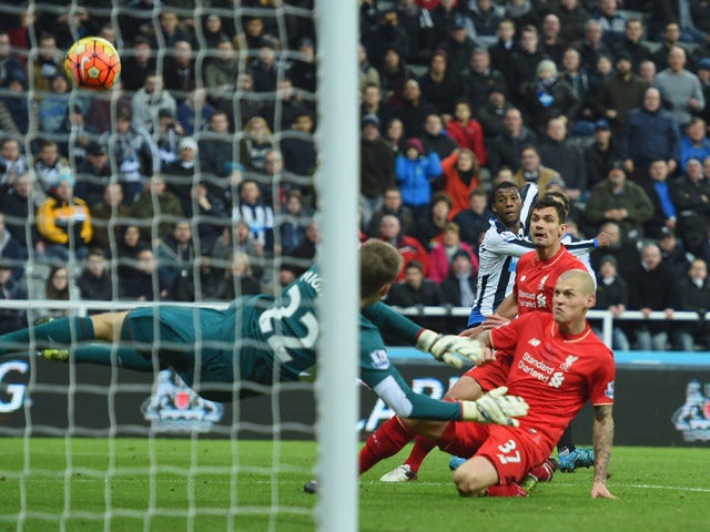Martin Skrtel of Liverpool (37) deflects a cross from Georginio Wijnaldum of Newcastle United (3R) past goalkeeper Simon Mignolet of Liverpool for an own goal and Newcastle's first during the Barclays Premier League match between Newcastle United and Live