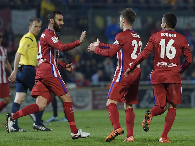 Atletico Madrid's Argentinian forward Luciano Vietto (C) celebrates after scoring a goal with Atletico Madrid's defender Jesus Gamez (L) and Atletico Madrid's Argentinian midfielder Angel Correa (R) during the Spanish Copa del Rey (King's Cup) football ma