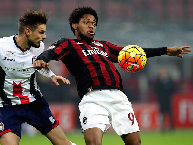 Luiz Adriano (R) of AC Milan is challenged by Michele Cremonesi (L) of FC Crotone during the TIM Cup match between AC Milan and FC Crotone at Stadio Giuseppe Meazza on December 1, 2015 in Milan, Italy. 
