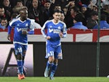 Marseille's French midfielder Remy Cabella (C) celebrates with teammates after scoring a goal during the French L1 football match Rennes against Marseille on December 03, 2015