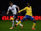 Max Clayton of Bolton Wanderers tackles Marc-Antoine Fortune of Wigan Athletic during the Sky Bet Championship match between Bolton Wanderers and Wigan Athletic at Macron Stadium on November 7, 2014