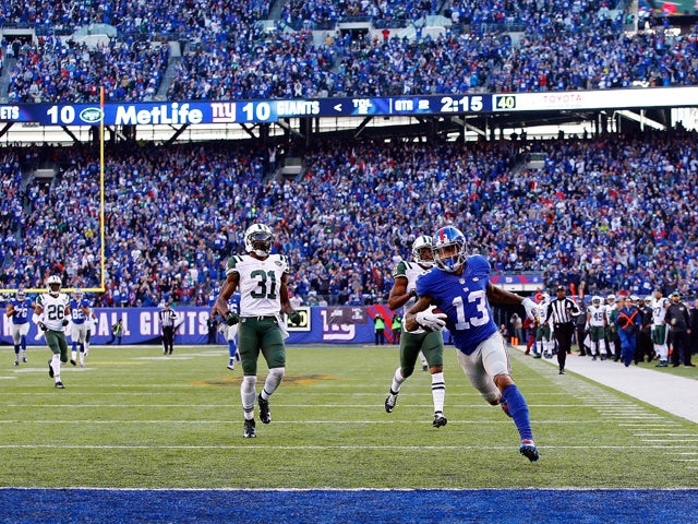 Odell Beckham Jr. #13 of the New York Giants runs with the ball on his way to scoring a 72 yard long touchdown against Marcus Gilchrist #21 and the New York Jets at MetLife Stadium on December 6, 2015