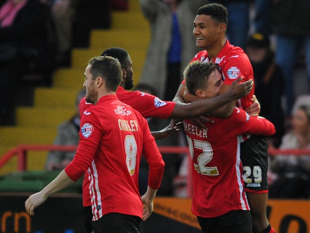 Ollie Watkins of Exeter City(R) celebrates after scoring his sides second goal during the Emirates FA Cup Second Round match between Exeter City and Port Vale at St James Park on December 6, 2015 in Exeter England.