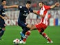 Arsenal's Fran Merida (L) vies for the ball with Olympiacos' Olof Mellberg during their UEFA Champions League football game at the Karaiskaki stadium in Athens on December 9, 2009.