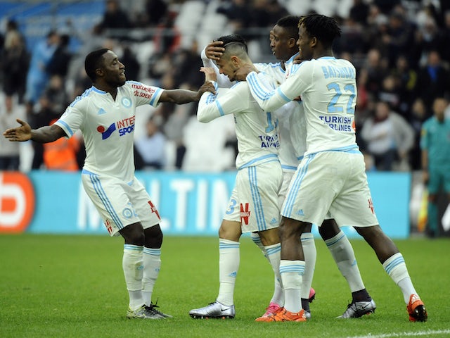 Marseille's French midfielder Remy Cabella (c) celebrates with his teammates after scoring a goal during the French L1 football match Olympique de Marseille against Montpellier on December 6, 2015 at Velodrome Stadium in Marseille, southern France. 