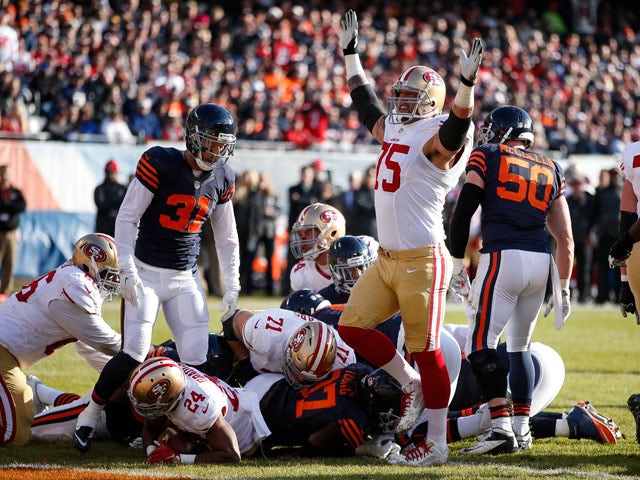 Alex Boone #75 of the San Francisco 49ers celebrates after Shaun Draughn #24 scored a touchdown against the Chicago Bears in the second quarter at Soldier Field on December 6, 2015