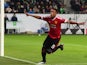Manchester United's French striker Anthony Martial reacts after scoring the opening goal during the UEFA Champions League Group B second-leg football match VfL Wolfsburg vs Manchester United in Wolfsburg, central Germany, on December 8, 2015.