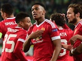 Manchester United's French striker Anthony Martial (c) reacts after scoring the opening goal during the UEFA Champions League Group B second-leg football match VfL Wolfsburg vs Manchester United in Wolfsburg, central Germany, on December 8, 2015.