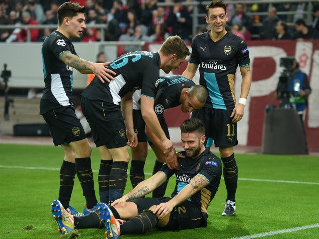 Olivier Giroud of Arsenal celebrates with his team-mates after scoring the second goal for Arsenal during the UEFA Champions League Group F match between Olympiacos FC and Arsenal FC at Karaiskakis Stadium on December 9, 2015 in Piraeus, Greece.