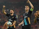 Per Mertesacker of Arsenal and Olivier Giroud of Arsenal celebrate at the end of Arsenal's win in the UEFA Champions League Group F match between Olympiacos FC and Arsenal FC at Karaiskakis Stadium on December 9, 2015 in Piraeus, Greece.