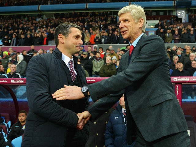 Remi Garde of Aston Villa and Arsene Wenger manager of Arsenal shake hands prior to the Barclays Premier League match between Aston Villa and Arsenal at Villa Park on December 13, 2015 in Birmingham, England.