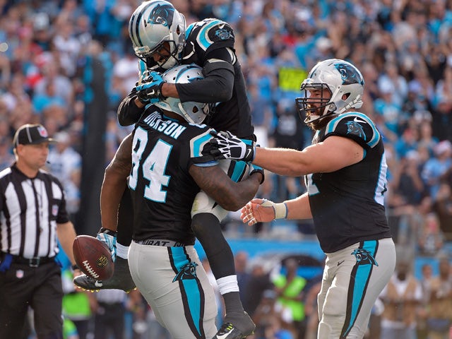 Ed Dickson #84 of the Carolina Panthers celebrates with teammates after making a touchdown catch against the Atlanta Falcons during their game at Bank of America Stadium on December 13, 2015