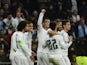 Real Madrid's Portuguese forward Cristiano Ronaldo (C) celebrates with teammates after scoring his fourth goal during the UEFA Champions League Group A football match Real Madrid CF vs Malmo FF at the Santiago Bernabeu stadium in Madrid on December 8, 201