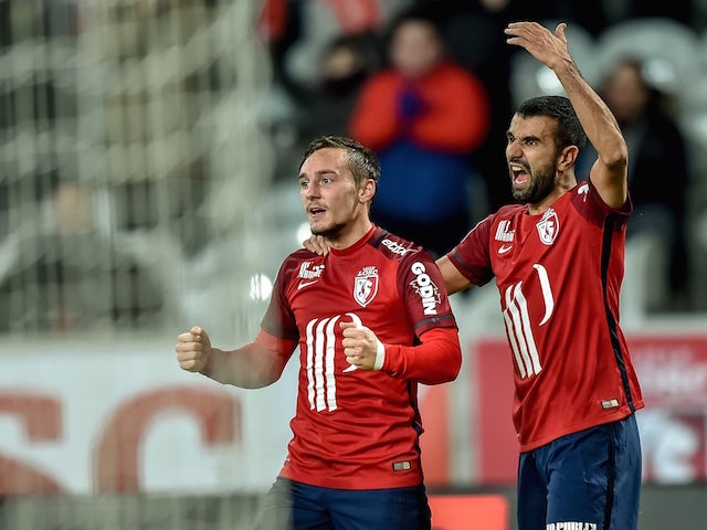 Lille's French midfielder Eric Bautheac (L) celebrates after scoring a goal during the French L1 football match between Lille OSC and FC Lorient on December 12, 2015 at the Pierre Mauroy Stadium in Villeneuve d'Ascq, northern France.
