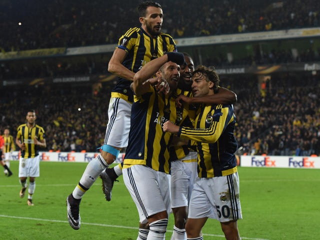 Fenerbahce's Lazar Markovic (R) celebrates with his teammates after scoring during the UEFA Europa League football match between Fenerbahce and Celtic at Fenerbahce Sukru Saracoglu stadium in Istanbul on December 10, 2015