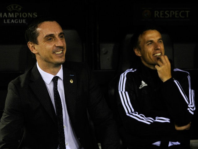 Gary Neville (L) manager of Valencia and Phil Neville assistant manager of Valencia look on from the bench prior to the UEFA Champions League Group H match between Valencia CF and Olympique Lyonnais at Estadio Mestalla on December 9, 2015 in Valencia, Spa