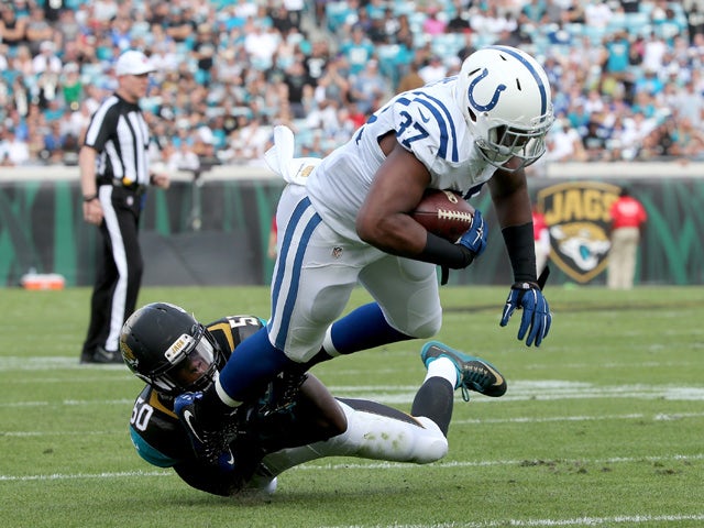 Telvin Smith #50 of the Jacksonville Jaguars tackles Zurlon Tipton #37 of the Indianapolis Colts during the game at EverBank Field on December 13, 2015