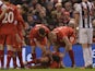 Liverpool's English midfielder James Milner (L) and Liverpool's Slovakian defender Martin Skrtel (R) aid Liverpool's Croatian defender Dejan Lovren (C) who was injured in a challenge with West Bromwich Albion's English midfielder Craig Gardner during the 