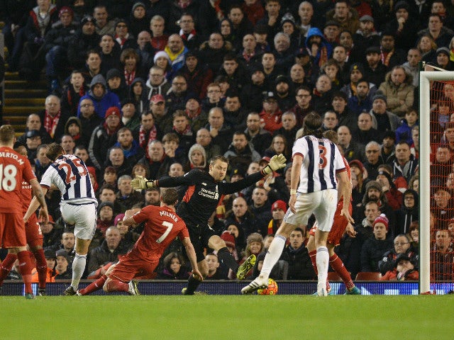 West Bromwich Albion's English defender Craig Dawson (3L) shoots and scores their first goal to equalise 1-1 during the English Premier League football match between Liverpool and West Bromwich Albion at Anfield in Liverpool, northwest England, on Decembe