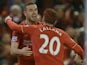 Liverpool's English midfielder Jordan Henderson (L) celebrates with Liverpool's English midfielder Adam Lallana (R) after scoring the opening goal during the English Premier League football match between Liverpool and West Bromwich Albion at Anfield in Li