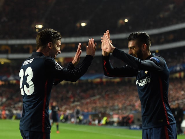 Atletico Madrid's Argentinian forward Luciano Vietto (L) celebrates with a teammate after scoring a goal during the UEFA Champions League Group C football match SL Benfica vs Club Atletico de Madrid at the Luz stadium in Lisbon on December 8, 2015.
