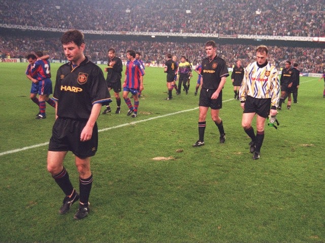 Dennis Irwin leads the Manchester United players off the field after they lost 4-0 to Barcelona on November 2, 1994