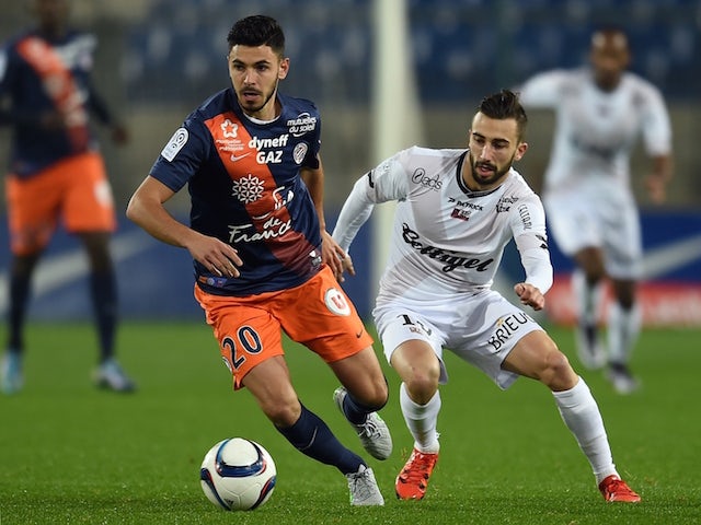 Montpellier's French midfielder Morgan Sanson (L) vies with Guingamp's French midfielder Nicolas Benezet during the French L1 football match between Montpellier and Guingamp, at the La Mosson Stadium in Montpellier, southern France, on December 12, 2015.