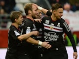 Nice's French forward Valere Germain (2nd L) is congratulated by teammates after scoring a goal during the French L1 football match between Reims and Nice at Auguste Delaune Stadium in Reims on December 12, 2015
