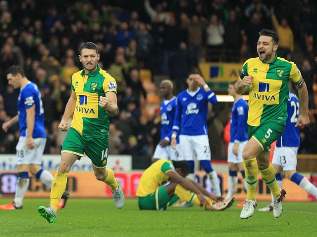 Wes Hoolahan (L) of Norwich City celebrates scoring his team's first goal with his team mate Russel Martin (R) during the Barclays Premier League match between Norwich City and Everton at Carrow Road on December 12, 2015