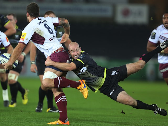 Ospreys' English flanker James King (L) is tackled during the European Rugby Champions Cup pool rugby union match between Ospreys and Bordeaux-Begles at Liberty Stadium in Swansea, South Wales, on December 12, 2015.