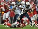 Melvin Gordon #28 of the San Diego Chargers runs through the tackle attempt of Tyvon Branch #27 of the Kansas City Chiefs at Arrowhead Stadium during the third quarter of the game on December 13, 2015