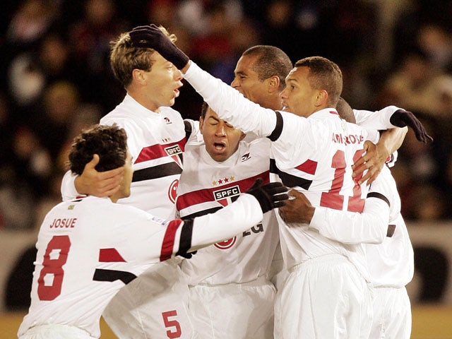 Brazil's Sao Paulo FC midfielder team members celebrate after midfielder Mineiro (R) scored a goal during the final of the Toyota Cup FIFA Club World Championship against England's Liverpool FC at the Yokohama stadium 18 December 2005