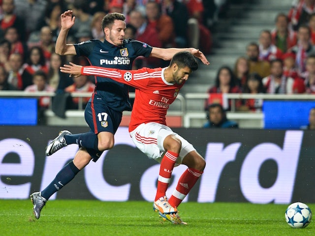 Atletico Madrid's midfielder Saul Niguez (L) vies with Benfica's Argentine defender Lisandro Lopez (R) during the UEFA Champions League Group C football match SL Benfica vs Club Atletico de Madrid at the Luz stadium in Lisbon on December 8, 2015.
