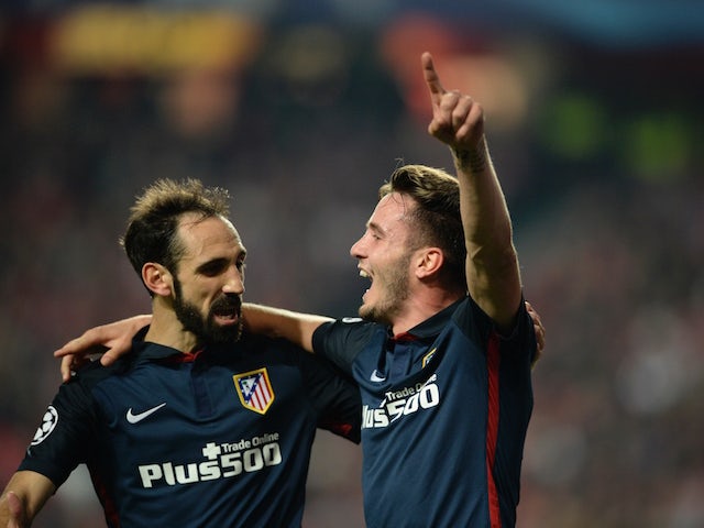 Atletico Madrid's midfielder Saul Niguez (R) celebrates with his teammate Atletico Madrid's defender Juanfran (L) after scoring a goal against SL Benfica during the UEFA Champions League Group C football match SL Benfica vs Club Atletico de Madrid at the 