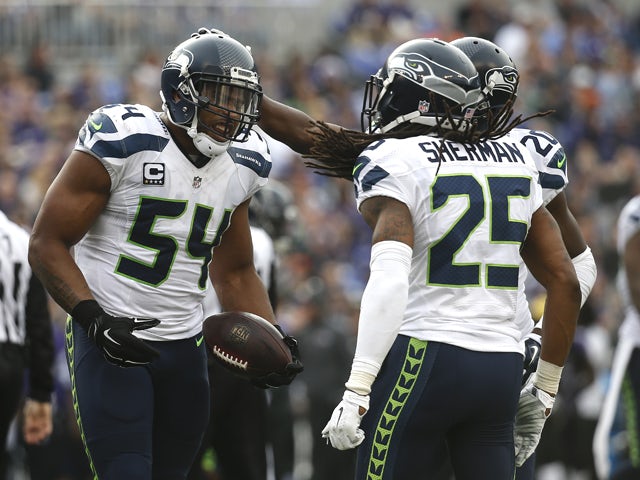 Middle linebacker Bobby Wagner #54 of the Seattle Seahawks celebrates with teammates cornerback Richard Sherman #25 and cornerback Jeremy Lane #20 after recovering a fumble against the Baltimore Ravens in the second quarter at M&T Bank Stadium on December