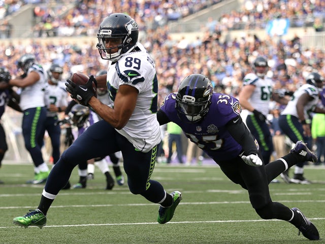 Wide receiver Doug Baldwin #89 of the Seattle Seahawks runs to score a second quarter touchdown past defensive back Shareece Wright #35 of the Baltimore Ravens at M&T Bank Stadium on December 13, 2015 