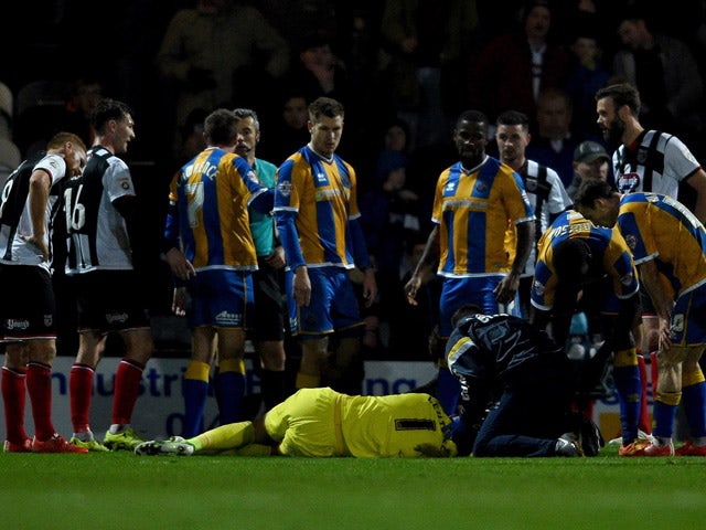 Jason Leutwiler of Shrewsbury is injured in a clash with Andy Monkhouse of Grimsbury during the Emirates FA Cup second round match between Grimsby Town and Shrewsbury Town at Blundell Park on December 7, 2015
