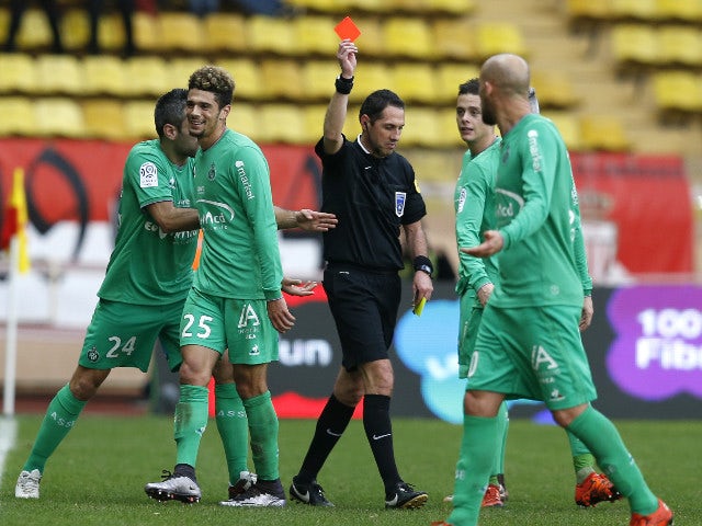 Referee Mikael lesage delivers a red card to Saint Etienne's defender Kevin Malcuit (2ndL) during the French L1 football match Monaco (ASM) vs Saint Etienne (ASSE) on december 13, 2015 at the 'Louis II Stadium' in Monaco.